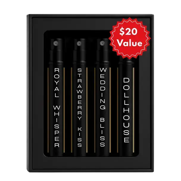 Set of four black travel-sized discovery perfume oil sprays in sleek bottles with gold stripes and white lettering