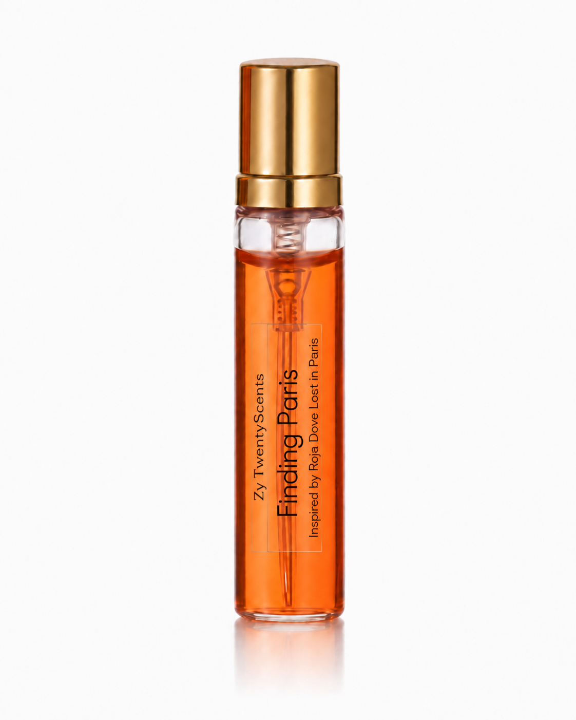 A clear glass rollerball bottle filled with orange fragrance oil, featuring a metallic gold cap and vertical text that reads 'Zy Twenty Scents Finding Paris'.